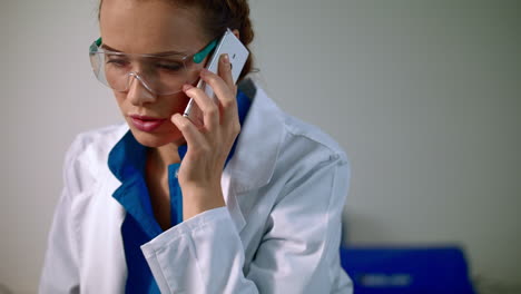 Woman-scientist-talking-on-phone.-Scientist-woman-talking-on-phone